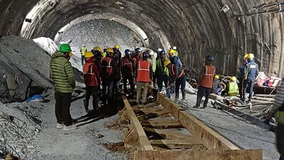 This handout photo taken on November 13, 2023, and released by the State Disaster Response Force (SDRF) shows rescue workers at the site after a tunnel collapsed in the Uttarkashi district of India's Uttarakhand state. More than a hundred rescuers in northern India struggled for a third day on November 14 to save workers trapped underground after the road tunnel they were building collapsed. (Photo by State Disaster Response Force (SDRF) / AFP) / RESTRICTED TO EDITORIAL USE - MANDATORY CREDIT "AFP PHOTO / State Disaster Response Force (SDRF)" - NO MARKETING NO ADVERTISING CAMPAIGNS - DISTRIBUTED AS A SERVICE TO CLIENTS
