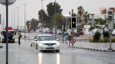 Cars go through puddles as the rain comes down in Dubai. Chris Whiteoak / The National