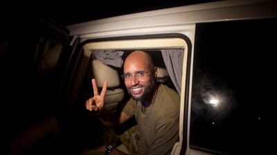 Moammar Gadhafi's son Seif al-Islam makes the victory sign as he appears at the Rixos hotel in Tripoli, Libya, Tuesday, Aug. 23, 2011. Al-Islam, who was earlier reported arrested by Libya's rebels, appeared at the hotel and spoke to reporters early Tuesday. (AP Photo/Dario Lopez-Mills)