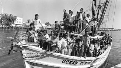 "One day, thinking that a change of country would save me from the madness, I left Cuba and arrived in this great American country." A shrimp boat packed with Cuban refugees lands at Florida's Key West Naval Base on April 30, 1980.