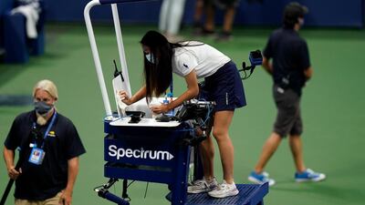 A woman cleans the chair umpire's seat before Naomi Osaka, of Japan, faces Misaki Doi, of Japan. AP Photo