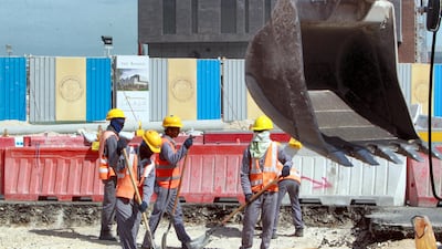 Workers are seen at a construction site in Doha. Qatar, host of the 2022 football World Cup, has been urged to improve conditions for labourers. AFP PHOTO/STR / AFP PHOTO / -