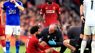 Liverpool's Mohamed Salah is attended to by medical staff. Press Association