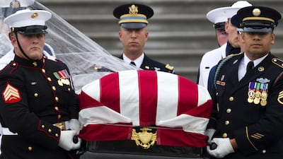 The flag-draped casket of John McCain is carried to a hearse from the US Capitol in Washington. AP