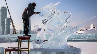 A participant carves his ice sculpture. EPA