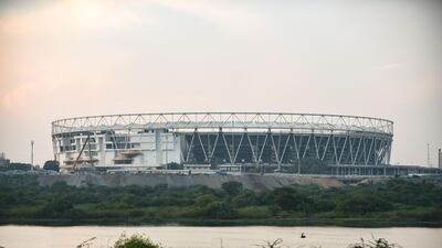 An Indian fisherman on the Sabarmati river which runs next to the world's largest cricket stadium being constructed in Motera. AFP
