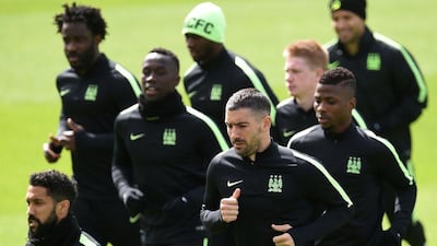 Manchester City’s French defender Gael Clichy (L), Manchester City’s Serbian defender Aleksandar Kolarov (C) and Manchester City’s Nigerian striker Kelechi Iheanacho (R) warm up during a team training session at the City Academy in Manchester, north west England, on May 3, 2016. Manchester City will play against Real Madrid CF in a Uefa Champions League semi-final second leg football match in Madrid on May 4. AFP / PAUL ELLIS