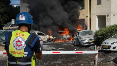 Cars burn after a rocket fired from the Gaza Strip hit a car park and residential building in Ashkelon, southern Israel. AP