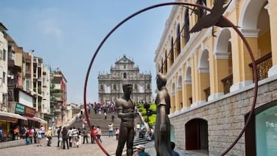 A bronze sculpture in Macau's Senado Square frames the ruins of the 17th-century St Paul's Church. Manfred Gottschalk / Lonely Planet