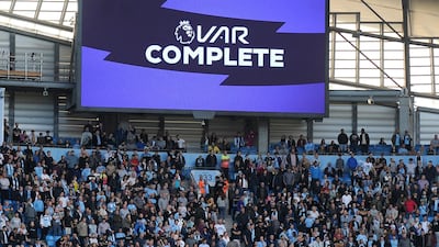 Fans wait while a possible goal by Manchester City's Gabriel Jesus is checked by VAR during the English Premier League soccer match between Manchester City and Tottenham Hotspur at Etihad stadium in Manchester, England. AP