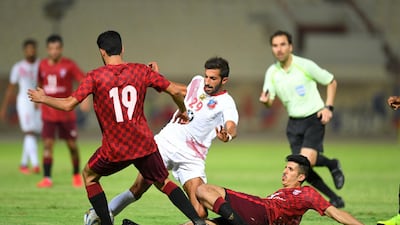 Kuwait SC player Ahmed Al-Zanki (centre) vies for the ball with Al-Nasr SC players during their Kuwaiti Premier League match at Al Kuwait Sports Club Stadium in Kuwait City, Kuwait. EPA