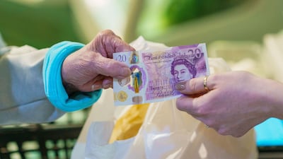 A shopper pays for groceries at an indoor market in Sheffield. Bloomberg