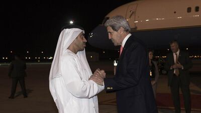Sheikh Abdullah bin Zayed, Minister of Foreign Affairs, left, and US Secretary of State John Kerry at the airport in Abu Dhabi. Kerry made a brief stop in the UAE on his way to China. Nicholas Kamm / Reuters