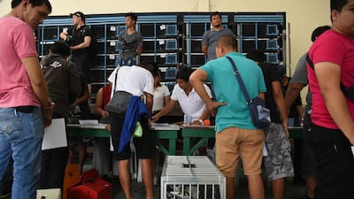 Pigeon fanciers register their birds at the office of the Philippine pigeon homing association's office.