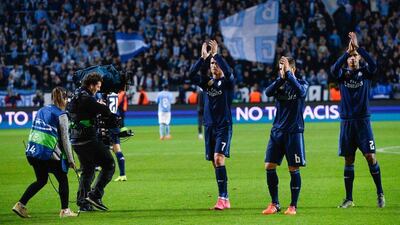 Real Madrid's Cristiano Ronaldo, left, and Nacho, centre and Raphael Varane applaud supporters after their Champions League win on Wednesday night. Jonathan Nackstrand / AFP