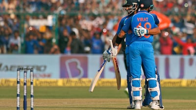 India's Rohit Sharma, left, hugs captain Virat Kohli after scoring a century during their third one-day international against New Zealand in Kanpur. Altaf Qadri / AP Photo