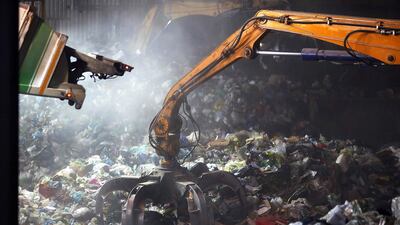 A digger removes waste at the Malagrotta landfill owned by Italian businessman Manlio Cerroni, who faces trial over allegations he monopolised trash disposal in and around the Italian capital using a web of companies and individuals. Alessandro Bianchi / Reuters