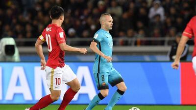 Andres Iniesta controls the ball in front of Guangzhou Evergrande midfielder Zheng Zhi. Toshifumi Kitamura / AFP