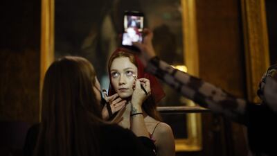 Models are made up backstage ahead of the Bora Aksu fashion show. AFP