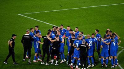 The players and coaching staff of Slovenia celebrate at full-time. Getty Images