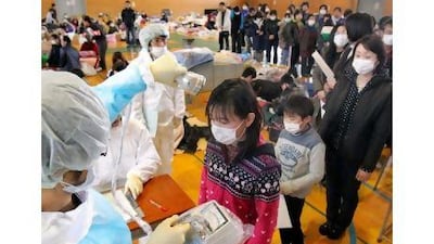 Japanese medical personnel check a child for radiation exposure in Fukushima. Turkish officials say that what happened at Japan's nuclear facilities will not stop the nation's plant to build power plants.