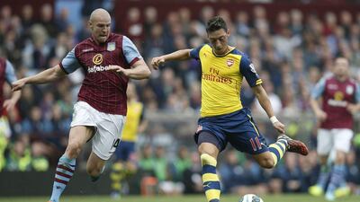 Arsenal's Mesut Ozil shoots and scores their opening goal against Aston Villa on Saturday in his side's English Premier League victory. Adrian Dennis / AFP / September 20, 2014