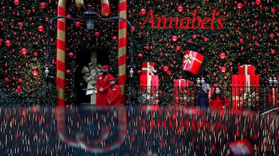 Staff stand outside the Christmas-themed entrance to Annabel's private members' club in London, UK. AFP