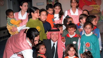 King Abdullah with orphans in Amman in February 1999. AFP