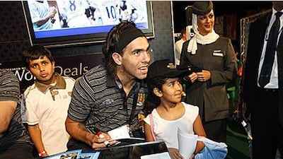 Carlos Tevez, here posing with children during Manchester City's stay in Abu Dhabi yesterday, said he was wanted by some of Europe's leading clubs but chose the Eastlands club