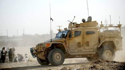 British army troops patrol Lashkar Gar in Afghanistan yesterday. Britain's military budget cuts will not directly affect the Afghan operation.