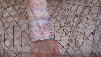 Another shows an Emirati woman's hand with a traditional fishing net. Courtesy Alia Al Joker