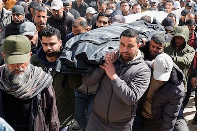 Palestinians attend the funeral of Hamas political leader Salah Al Bardaweel and his wife, killed in an Israeli strike in Khan Younis on Saturday. Reuters