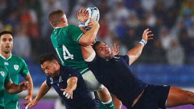 Ireland wing Andrew Conway, centre, jumps for the ball in Yokohama. AFP