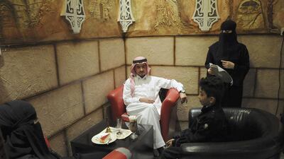 A veiled Saudi waitress speaks to visitors at a coffee shop in Tabuk. Of the 4.4 million jobs created in the 2003 through 2013 decade of booming oil prices and prosperity, about 1.7 million, 39 per cent, were taken by Saudis, according to the McKinsey Global Institute. Mohamed Alhwaity / Reuters