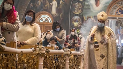 A priest leads Christmas Mass at the Archangel Michael Coptic Orthodox Church. Many Orthodox Christians celebrate Christmas on or near January 7, as their churches follow the Julian calendar. AFP