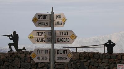 Silhouette sculptures of Israeli soldiers are pictured next to a sign for tourists showing the respective distances to Damascus and Baghdad from an army post on Mount Bental in the Israeli-annexed Golan Heights. AFP Photo