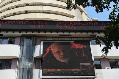 A digital broadcast shows an image of Indian Prime Minister Narendra Modi next to stock prices outside the Bombay Stock Exchange in Mumbai. AFP