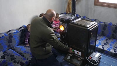 Abu Walid adjusts the temperature of a pistachio-powered heater with a dial regulating the number of shells burned per minute. AFP