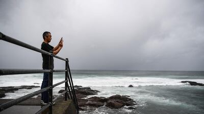 A man takes pictures of the coast as Typhoon Haishen approaches in Makurazaki, Kagoshima prefecture. AFP