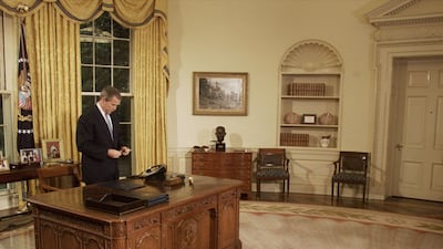 President George W Bush talks with former first lady Nancy Reagan on the telephone after signing a Joint Resolution commemorating Ronald Reagan's 90th birthday on February 15, 2001. Photo: Newsmakers