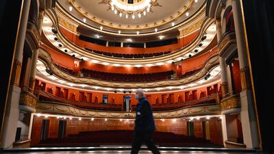 A man walks on the empty stage of the Theatre de la Sinne, in Mulhouse, eastern France, on the eve of a new lockdown in France. AFP