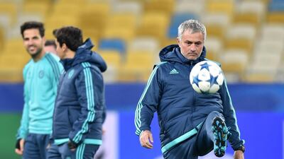 Chelsea's Portuguese coach Jose Mourinho (R) kicks a ball during a training session at Olimpiskiy Stadium in Kiev on October 19, 2015, a day before their Champion's League Group G football match against FC Dinamo. AFP PHOTO / SERGEI SUPINSKY