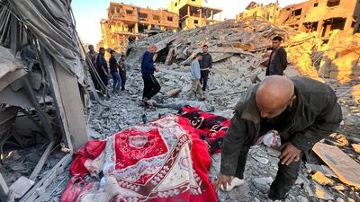 The bodies of victims are covered with blankets following an overnight Israeli strike in Beit Lahia, Gaza last month. AFP