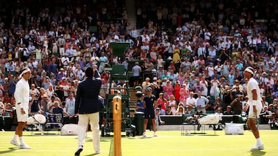 LONDON, ENGLAND - JULY 12: The chair umpire performs the coin toss ahead of the Men's Singles semi-final match between Roger Federer of Switzerland and Rafael Nadal of Spain during Day eleven of The Championships - Wimbledon 2019 at All England Lawn Tennis and Croquet Club on July 12, 2019 in London, England. (Photo by Clive Brunskill/Getty Images)