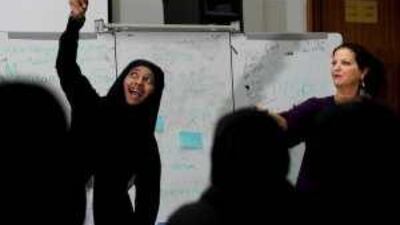 Fatima Matar al Nyadi, a student gives her version of a bird during an exercise with the author Margaret Wolfson.