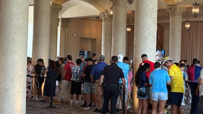 Fans queue to take a picture with the World Cup trophy. Kyle Fitzgerald / The National