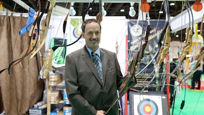 Hubert Wursthorn shows off a customised bow at his Archery Logistics stand at Adihex. Pawan Singh / The National