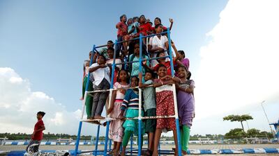 Children staying in the care home set up by Karibeeran Paramesvaran and his wife Choodamani after they lost three children in the 2004 tsunami, pose in a park along a beach in Nagapattinam district in the southern state of Tamil Nadu, India. REUTERS