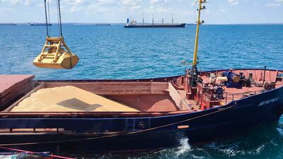 Grain is loaded aboard a cargo ship at the Azov Sea Port in Ukraine.AFP