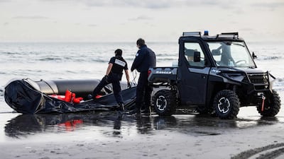 French National Police officers confiscate a dinghy.